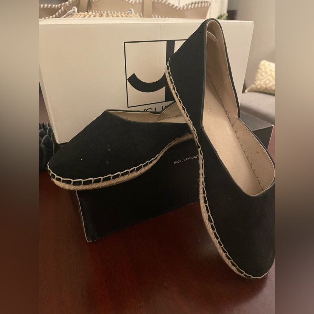 Black suede espadrilles with detailed stitching.